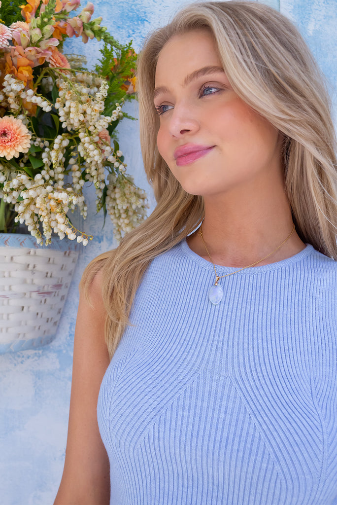 The Astro Ice Blue Knit Tank Top is a beautiful pastel blue tank top. The tank top features a high neck, stretchy knit fabric, ribbed texture and is fitted. 