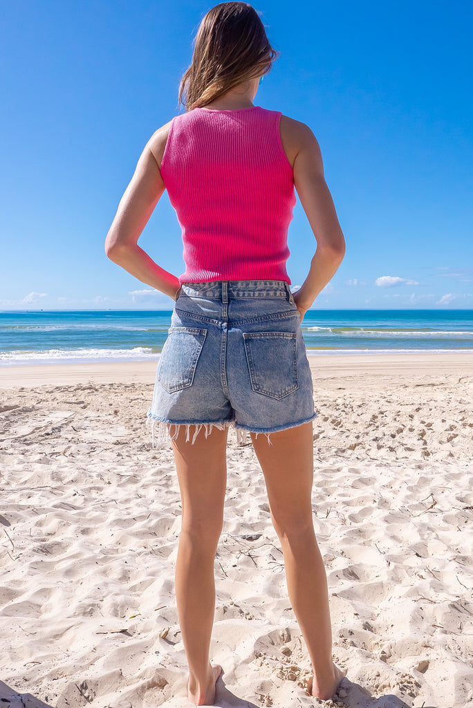 The Astro Pinkpop Knit Tank Top is a luxurious hot pink tank top. The tank top features a high neck, stretchy knit fabric, ribbed texture and is fitted. 