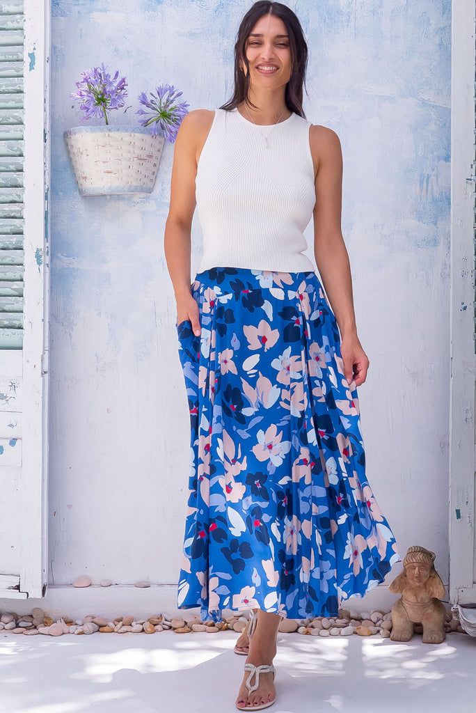 The Atlantis Blue Blooms Maxi Skirt is a beautiful dark blue based maxi skirt with a large floral print in blues and whites. The skirt features a double v-shaped waist yoke, inset panels on the front from the yoke down, very full skirt, elasticated back of waist and side pockets. This is a slip on design with a shapely hemline and slightly longer front due to the inset panels. Made from 100% rayon.