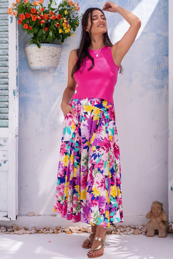 The Atlantis In Paradise Maxi Skirt is a beautiful, bold, bright and large, multicolour floral printed maxi skirt. The skirt features a double v-shaped waist yoke, inset panels on the front from the yoke down, very full skirt, elasticated back of waist and side pockets. This is a slip on design with a shapely hemline and slightly longer front due to the inset panels. Made from 100% rayon.