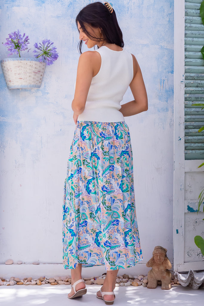The Atlantis Sea Swirl Maxi Skirt is a beautiful cream based maxi skirt with a paisley print in blues and greens. The skirt features a double v-shaped waist yoke, inset panels on the front from the yoke down, very full skirt, elasticated back of waist and side pockets. This is a slip on design with a shapely hemline and slightly longer front due to the inset panels. Made From 100% rayon.