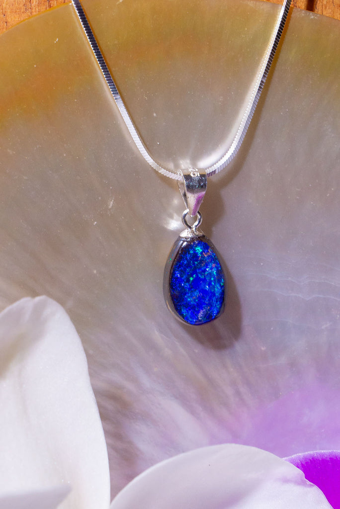 A Wonderful deep blue opal pendant, it has strong blue colour with some teal flashed in sunlight, polished to a high shine on the front and back. 