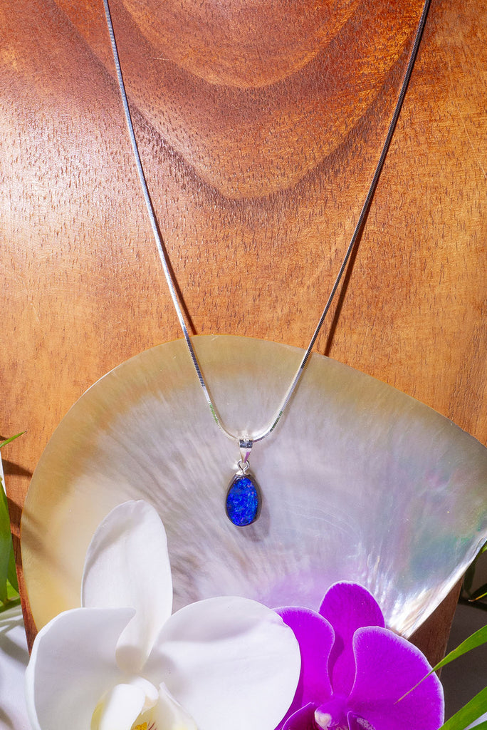 A Wonderful deep blue opal pendant, it has strong blue colour with some teal flashed in sunlight, polished to a high shine on the front and back. 