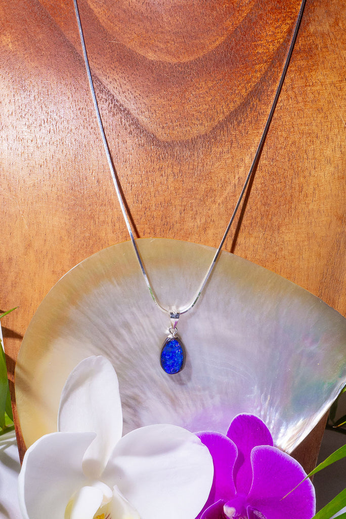 A Wonderful deep blue opal pendant, it has strong blue colour with some teal flashed in sunlight, polished to a high shine on the front and back. 