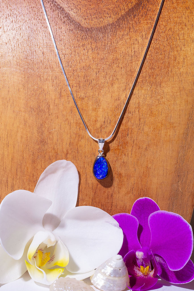 A Wonderful deep blue opal pendant, it has strong blue colour with some teal flashed in sunlight, polished to a high shine on the front and back. 