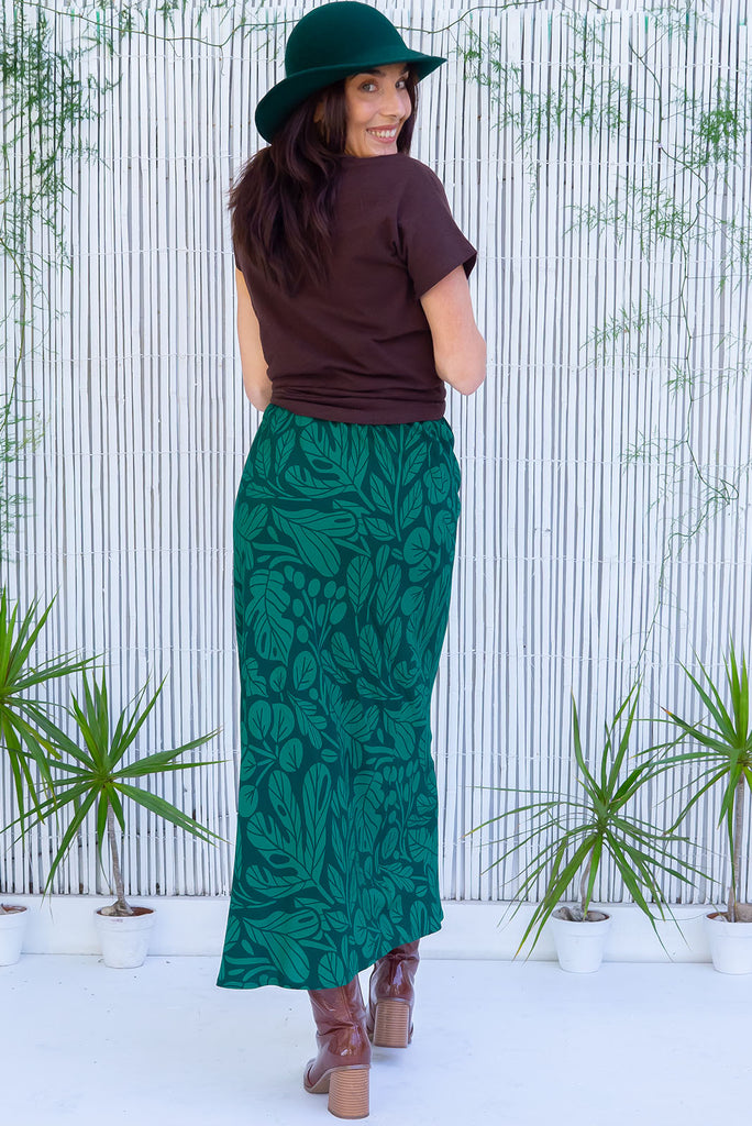 The Bianca Botany Bias Cut Maxi Skirt is a tonal green maxi skirt with a botanical silhouette print. The skirt features a bias cut, elasticated waist and belt loop with removable waist tie pocket. Made from 100% rayon.