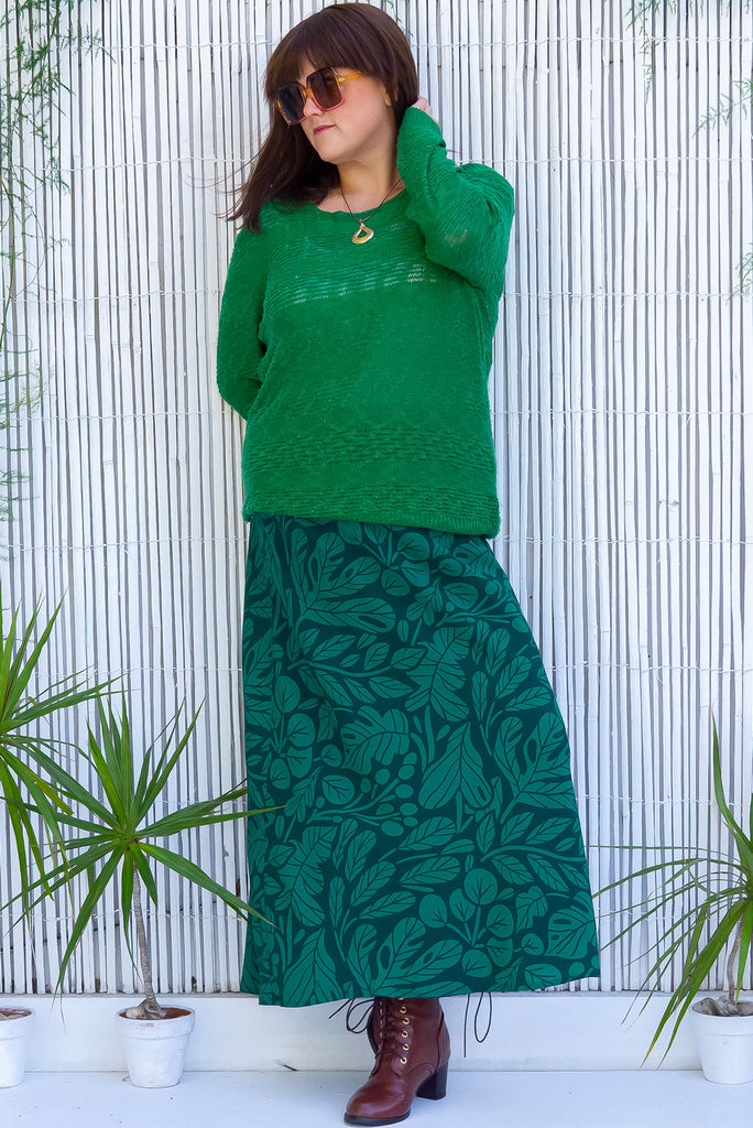 The Bianca Botany Bias Cut Maxi Skirt is a tonal green maxi skirt with a botanical silhouette print. The skirt features a bias cut, elasticated waist and belt loop with removable waist tie pocket. Made from 100% rayon.