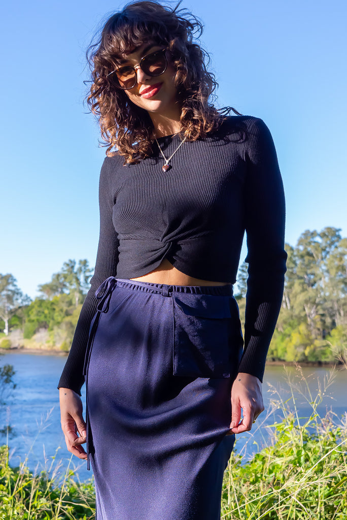 The Bianca Midnight Bias Cut Maxi Skirt is a navy maxi skirt with satin finish. The skirt features a bias cut, elasticated waist and belt loop with removable waist tie pocket. Made from viscose/rayon.