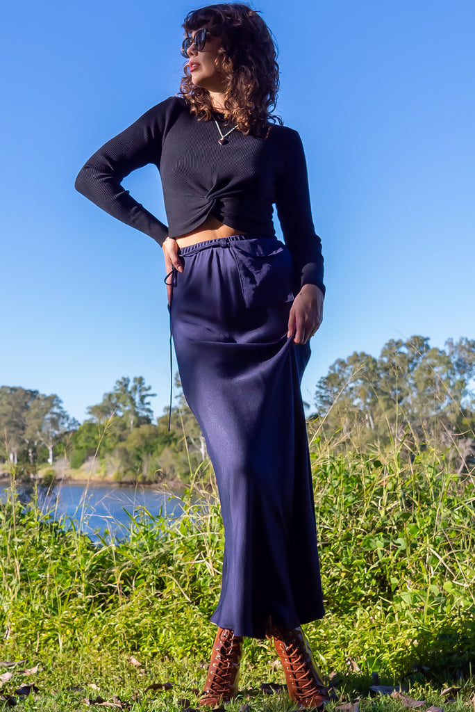 The Bianca Midnight Bias Cut Maxi Skirt is a navy maxi skirt with satin finish. The skirt features a bias cut, elasticated waist and belt loop with removable waist tie pocket. Made from viscose/rayon.