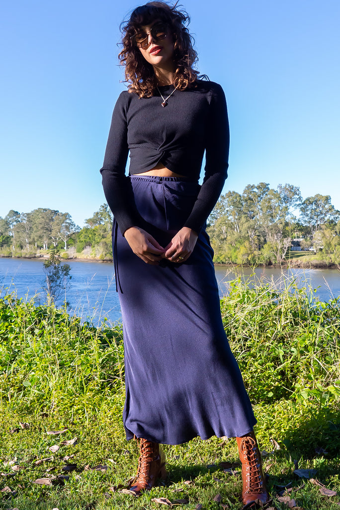 The Bianca Midnight Bias Cut Maxi Skirt is a navy maxi skirt with satin finish. The skirt features a bias cut, elasticated waist and belt loop with removable waist tie pocket. Made from viscose/rayon.