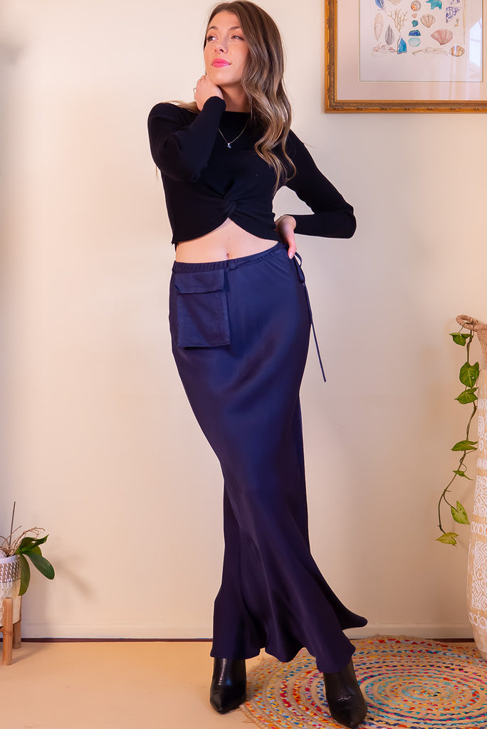 The Bianca Midnight Bias Cut Maxi Skirt is a navy maxi skirt with satin finish. The skirt features a bias cut, elasticated waist and belt loop with removable waist tie pocket. Made from viscose/rayon.