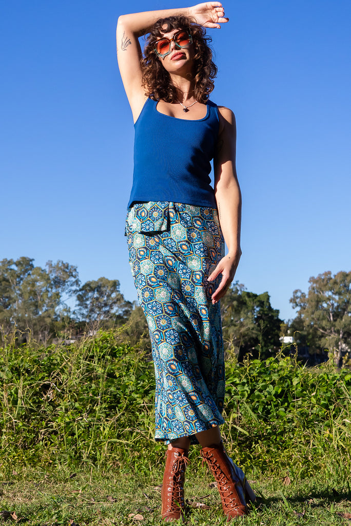 The Bianca Toledo Bias Cut Maxi Skirt is a beautiful blue skirt with a hexagonal Mexican tile print. The skirt features a bias cut, elasticated waist and belt loop with removable waist tie pocket. Made from 100% rayon.