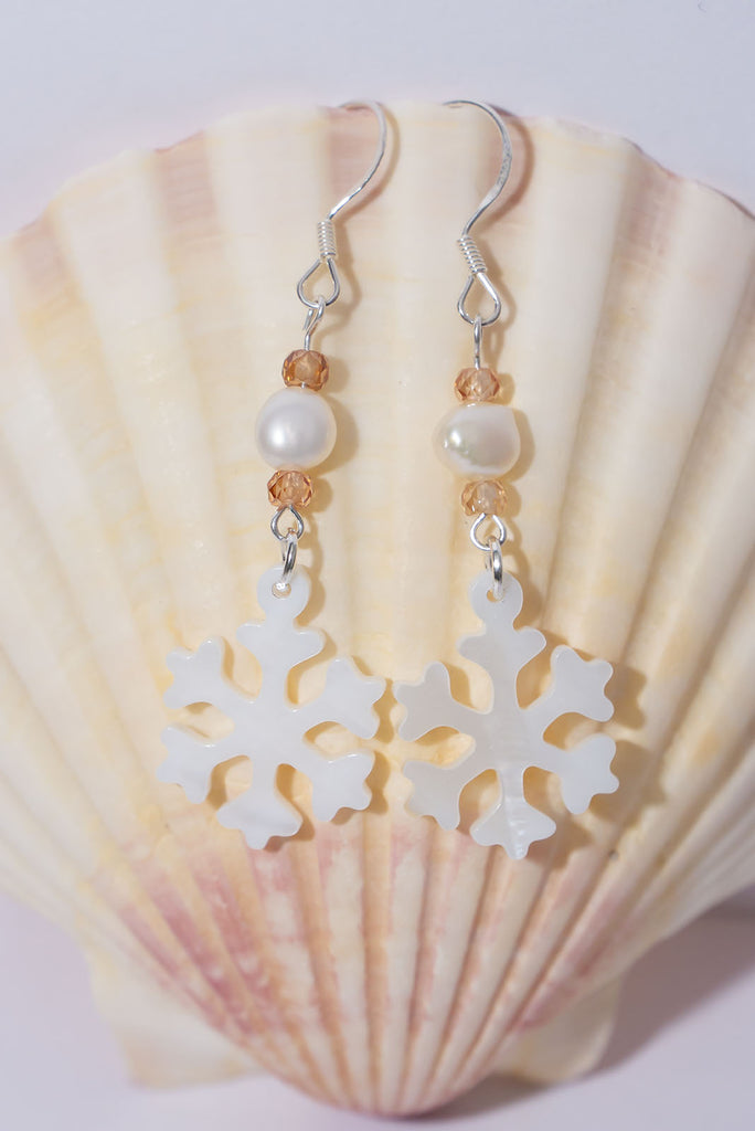 A snowflake on a South Pacific island, imagine that and this pretty carved mother of pearl snowflake has a tiny sparkling green Peridot bead as a highlight so dream on wearing our newest earring style.