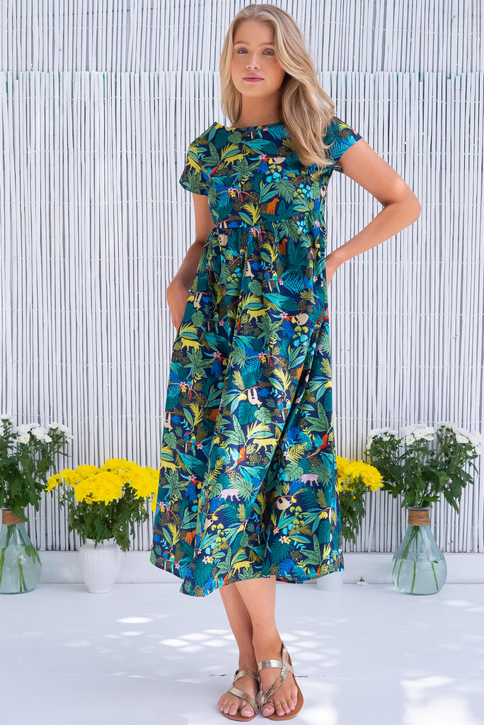 The Cocoloco Jungle Dress is a gorgeous navy based midi dress with a tropical jungle print. The dress features short sleeves, pockets, and is made from woven 100% cotton. 