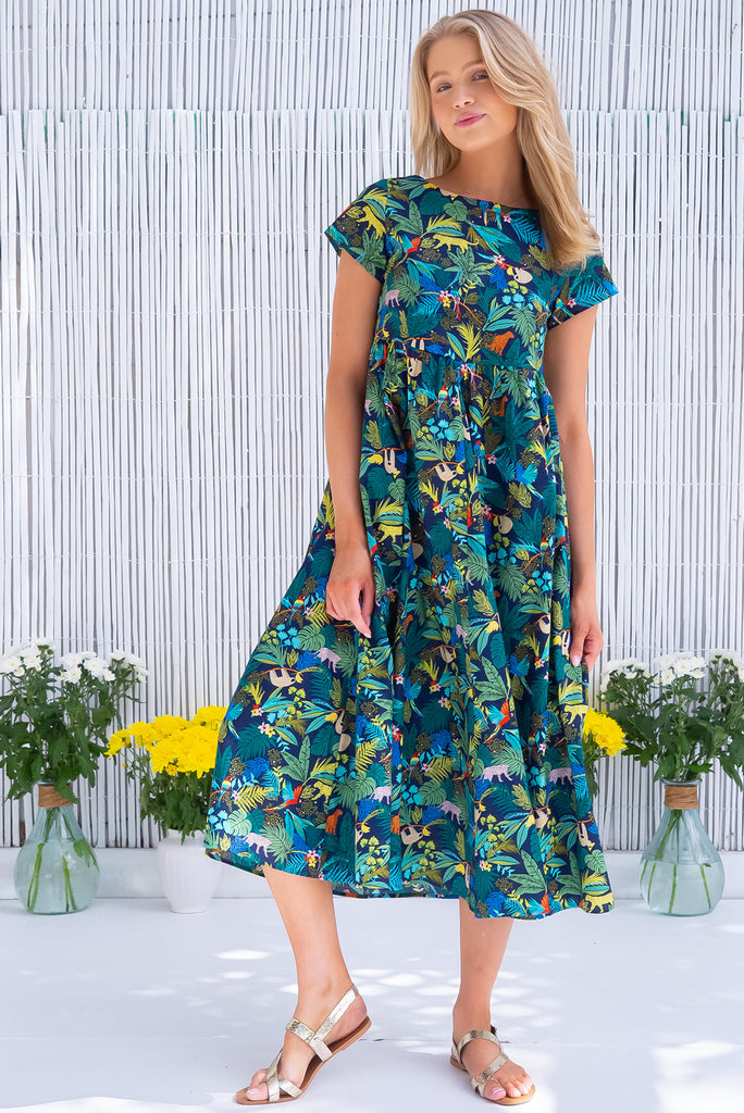The Cocoloco Jungle Dress is a gorgeous navy based midi dress with a tropical jungle print. The dress features short sleeves, pockets, and is made from woven 100% cotton. 