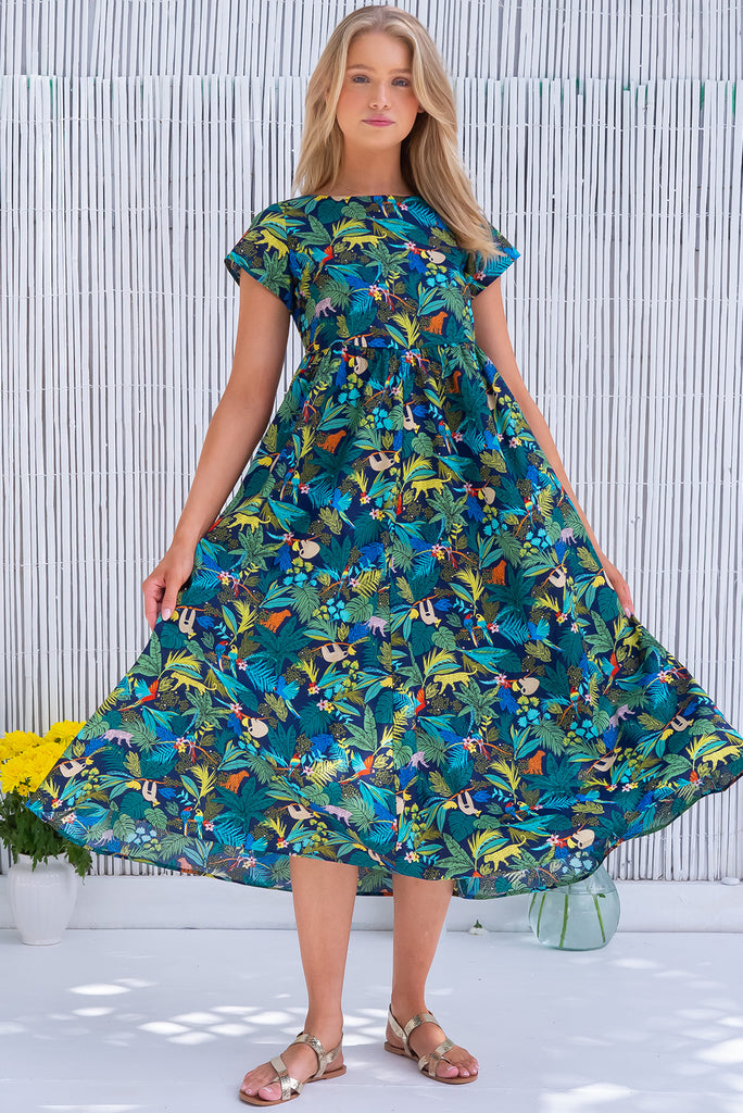 The Cocoloco Jungle Dress is a gorgeous navy based midi dress with a tropical jungle print. The dress features short sleeves, pockets, and is made from woven 100% cotton. 