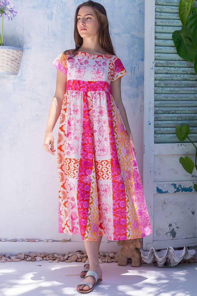 The Cocoloco Sungold Dress is a gorgeous pink and orange bohemian patch printed midi dress. The dress features short sleeves, pockets, and is made from woven 100% cotton. 