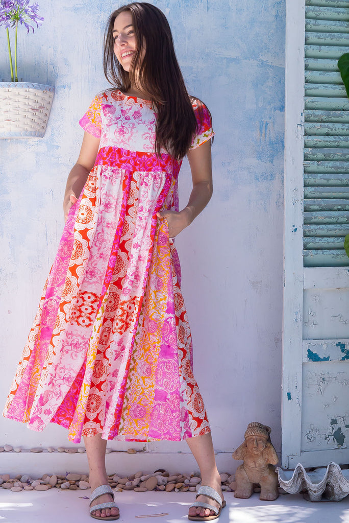 The Cocoloco Sungold Dress is a gorgeous pink and orange bohemian patch printed midi dress. The dress features short sleeves, pockets, and is made from woven 100% cotton. 