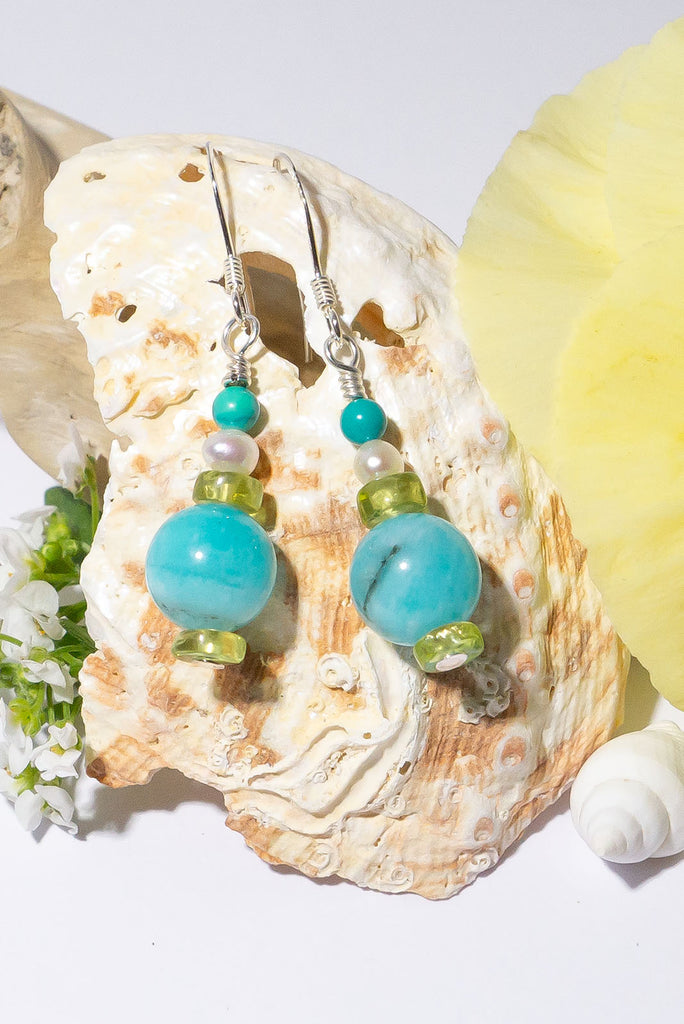 Featuring shades of a tropical lagoon these delicate gemstone droplet earrings are the perfect accessory for Spring & Summer.