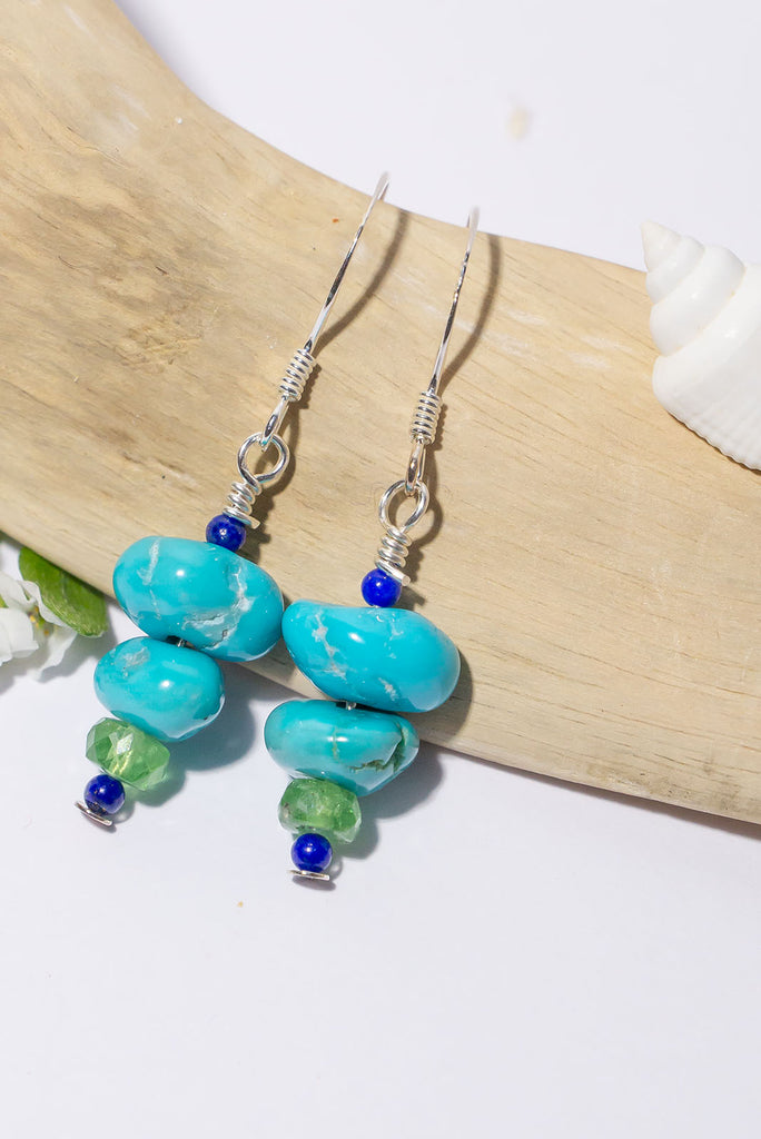 Tumbled Lone Mountain Turquoise in beautiful organic shapes is complimented by the beautiful green of tsavorite and the deep midnight blue of lapis lazuli.