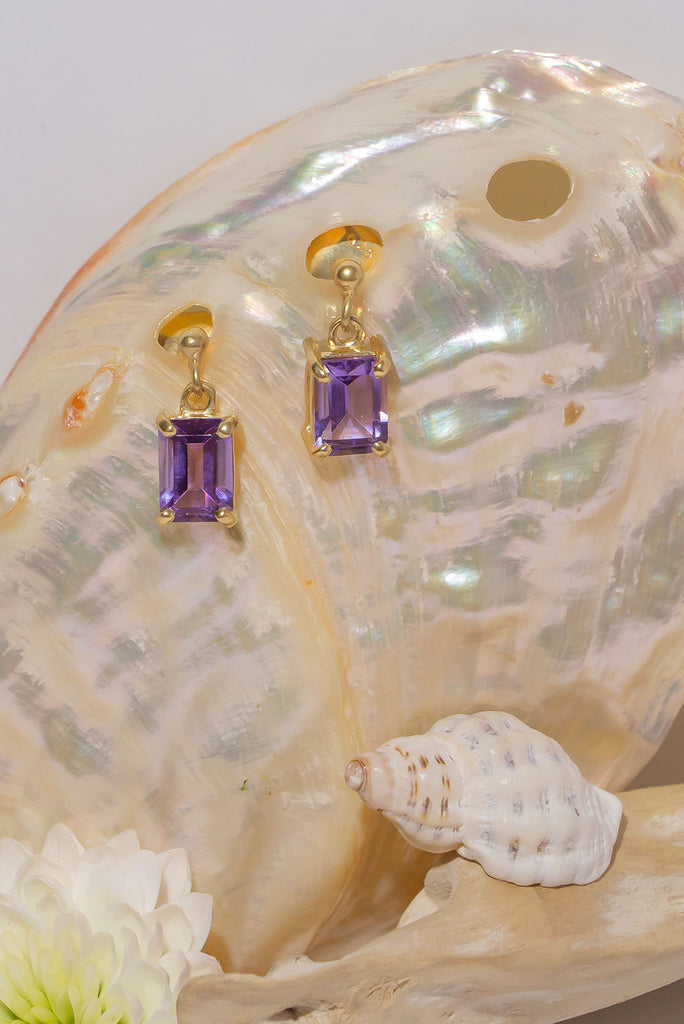 These sparkling clear Amethyst earrings are both romantic and chic. Pretty earrings with an emerald cut Amethyst gemstones set in 9ct gold vermeil. Made exclusively for Mombasa Rose Boutique.