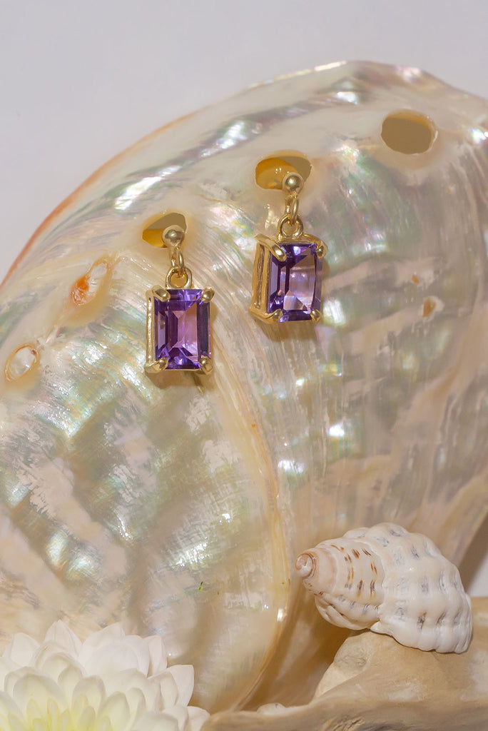 These sparkling clear Amethyst earrings are both romantic and chic. Pretty earrings with an emerald cut Amethyst gemstones set in 9ct gold vermeil. Made exclusively for Mombasa Rose Boutique.