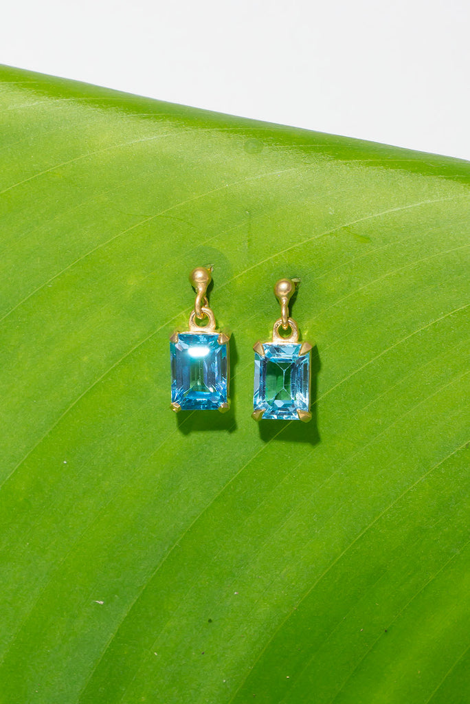 These pretty ocean coloured blue Topaz earrings are a perfect droplet of sea and sky. Pretty earrings with an emerald cut Blue Topaz gemstone set in 9ct gold vermeil. Made exclusively for Mombasa Rose Boutique.