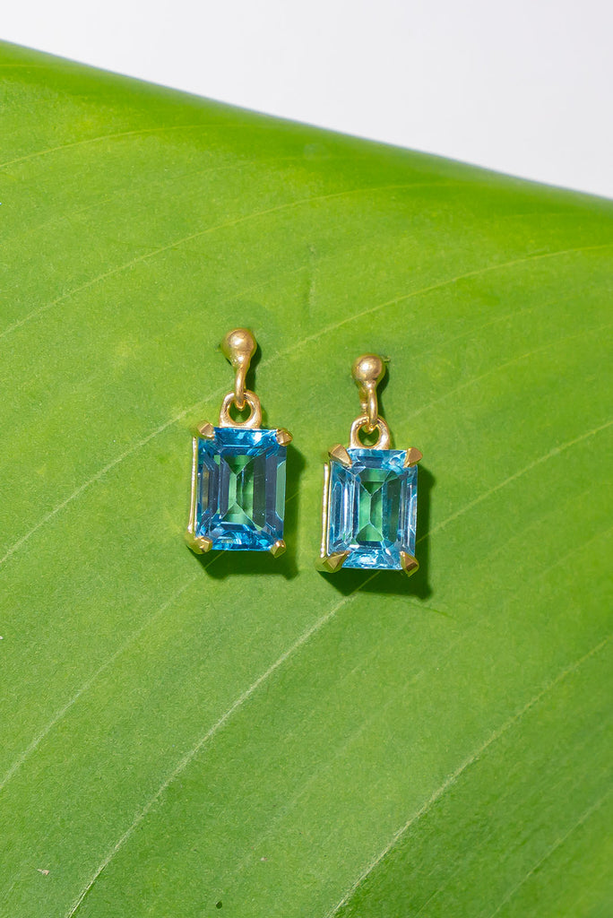 These pretty ocean coloured blue Topaz earrings are a perfect droplet of sea and sky. Pretty earrings with an emerald cut Blue Topaz gemstone set in 9ct gold vermeil. Made exclusively for Mombasa Rose Boutique.