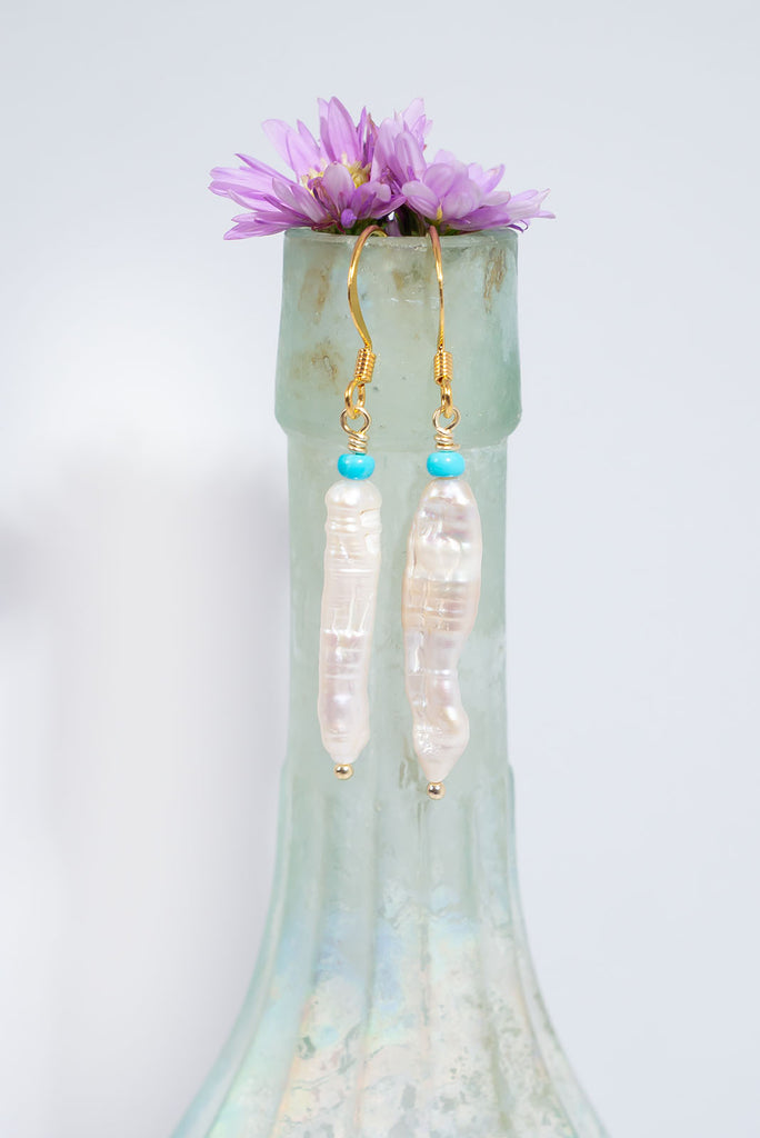 Get wrapped up in the whirling swirling beauty of these pearl and natural turquoise earrings.