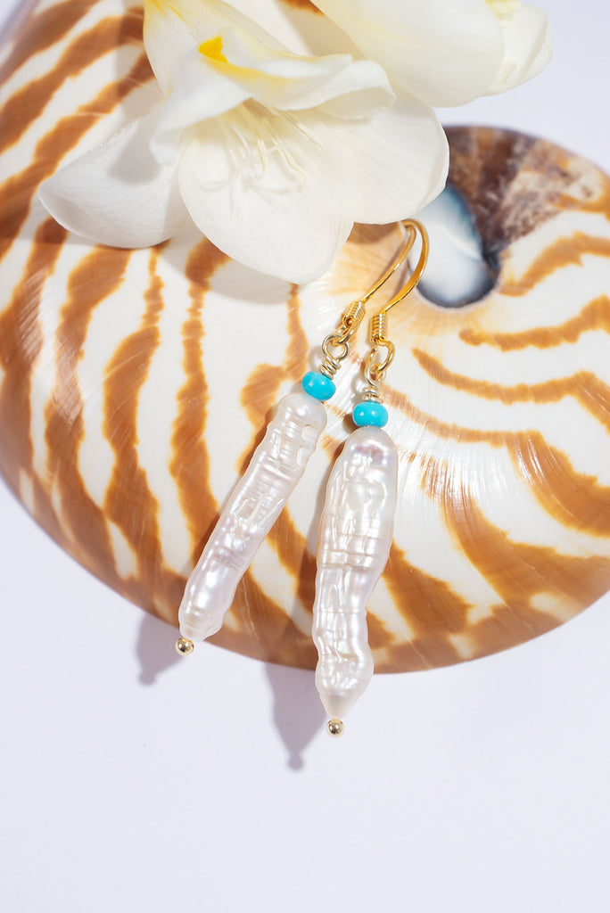 Get wrapped up in the whirling swirling beauty of these pearl and natural turquoise earrings.