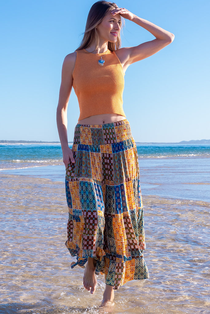 The Echo Golden Patch Maxi Skirt is a gorgeous maxi skirt with a bohemian style patchwork print in golden and blue tones. The skirt features an elasticated waistband, tiering and side pockets. Made from crinkle rayon.