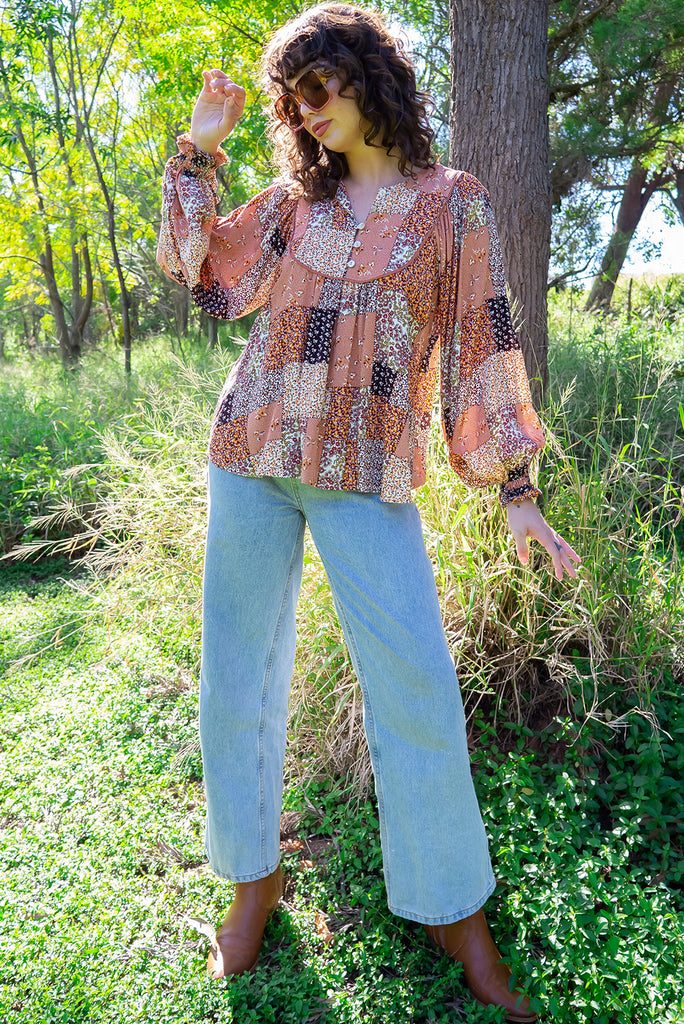 The Emmylu Caramel Patch Boho Blouse is a beautiful caramel toned patchwork print blouse. The blouse features a yoke neckline with functional buttons, long flowy sleeves with elasticated cuffs, and a slightly longer back. Made from woven 100% rayon. 
