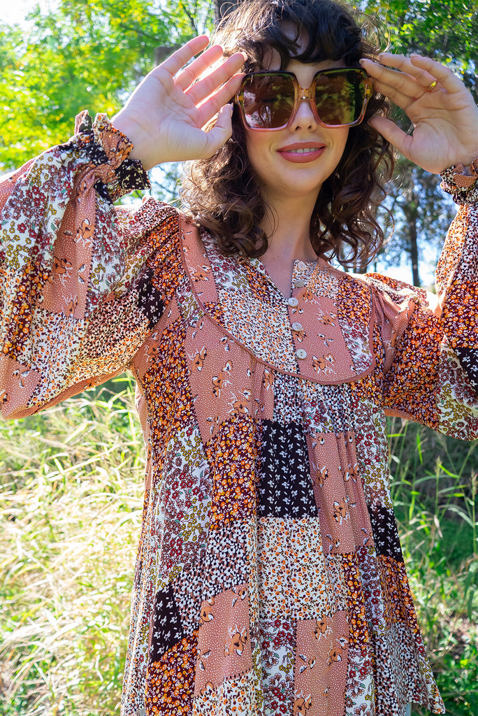 The Emmylu Caramel Patch Boho Blouse is a beautiful caramel toned patchwork print blouse. The blouse features a yoke neckline with functional buttons, long flowy sleeves with elasticated cuffs, and a slightly longer back. Made from woven 100% rayon. 