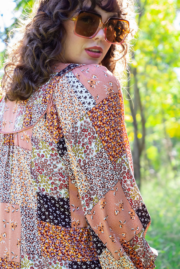 The Emmylu Caramel Patch Boho Blouse is a beautiful caramel toned patchwork print blouse. The blouse features a yoke neckline with functional buttons, long flowy sleeves with elasticated cuffs, and a slightly longer back. Made from woven 100% rayon. 