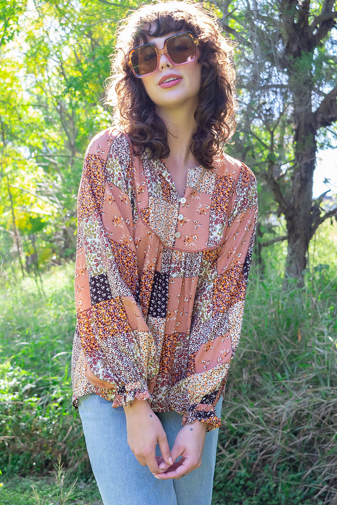 The Emmylu Caramel Patch Boho Blouse is a beautiful caramel toned patchwork print blouse. The blouse features a yoke neckline with functional buttons, long flowy sleeves with elasticated cuffs, and a slightly longer back. Made from woven 100% rayon. 