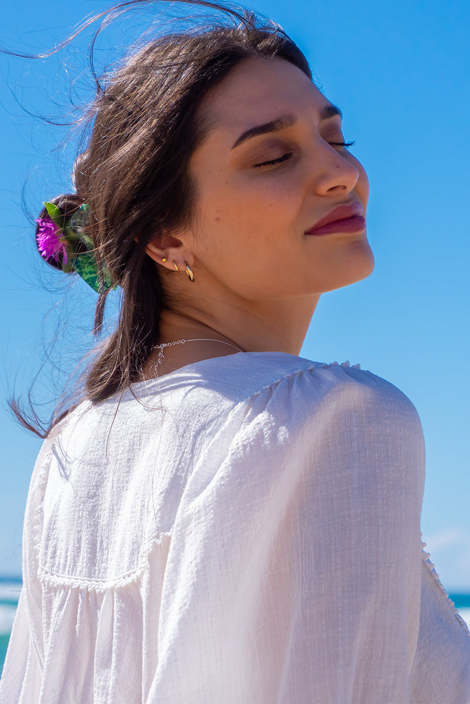 The Emmylu White Cotton Boho Blouse is a beautiful white blouse. The blouse features a yoke neckline with functional buttons, long flowy sleeves with elasticated cuffs, and a slightly longer back. Made from woven 100% cotton. 