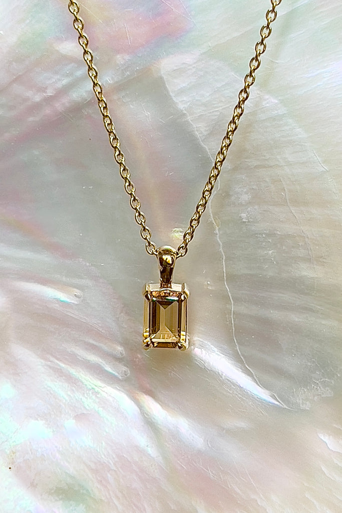 The pendant and chain are 9ct gold vermeil on a base of 925 silver, the gold is 2.5microns thick so will never rub or discolor An emerald cut Citrine gemstone set in 9ct gold vermeil. Citrine gemstone. Pendant is 4cm long. Chain is gold vermeil