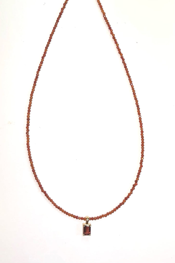 A delicate choker style necklace made with very tiny faceted and polished Carnelian beads, the centre piece is an emerald cut Garnet set in gold vermeil. Made for Mombasa Rose Boutique in Noosa Australia.