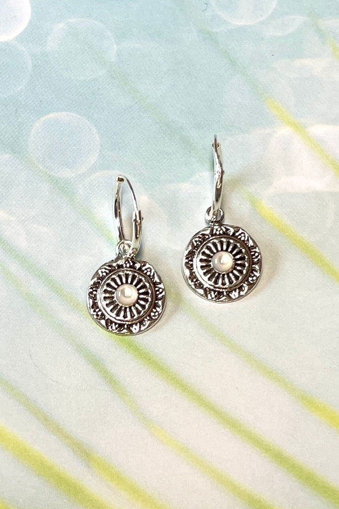 Tiny silver circle earrings with a small pearly centre bead, a perfect lightweight everyday earring with a hint of sophistication. These silver earrings are chic and subtle.  