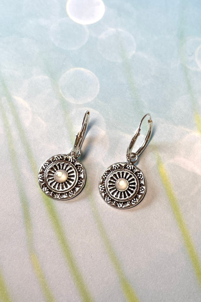 Tiny silver circle earrings with a small pearly centre bead, a perfect lightweight everyday earring with a hint of sophistication. These silver earrings are chic and subtle.  