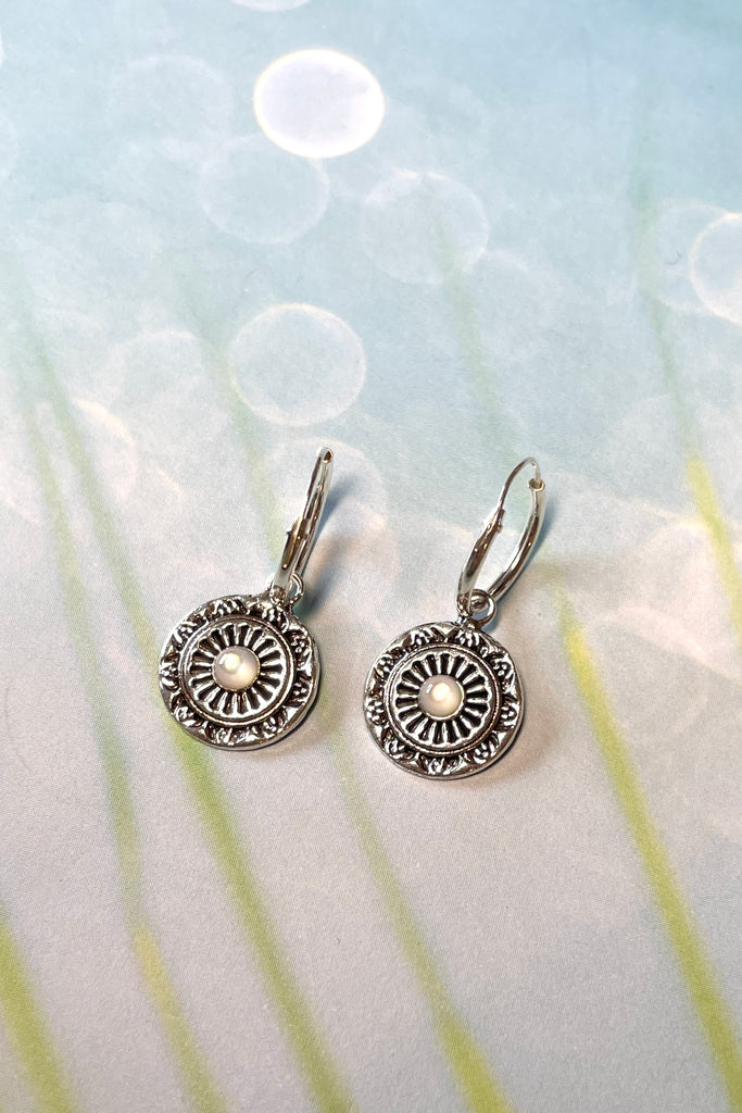 Tiny silver circle earrings with a small pearly centre bead, a perfect lightweight everyday earring with a hint of sophistication. These silver earrings are chic and subtle.  
