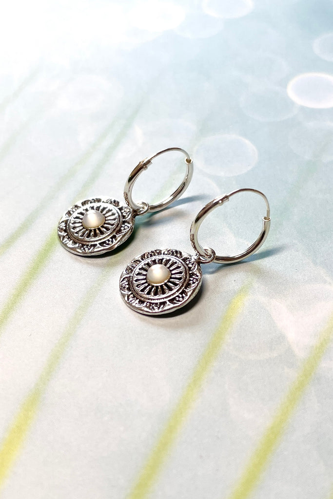 Tiny silver circle earrings with a small pearly centre bead, a perfect lightweight everyday earring with a hint of sophistication. These silver earrings are chic and subtle.  