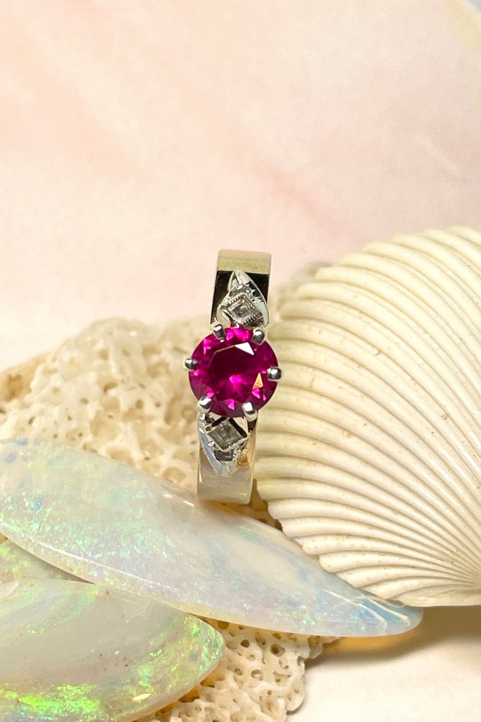 This stunning high set vintage ring features a bright Rhodolite Garnet gemstone. The band is wide and flat.  Pre worn with little signs of wear.