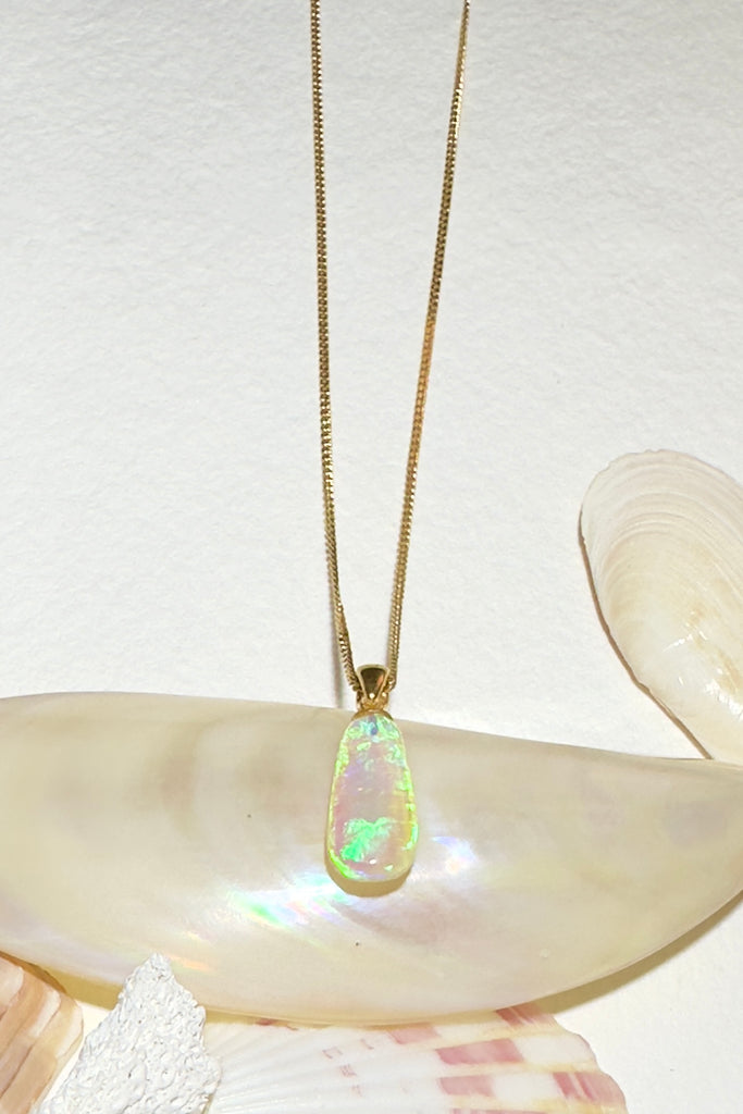 this clear Australian crystal Opal pendant is shot through with bright green, sky blue and soft mauve, its all the colours of nature and the sky.