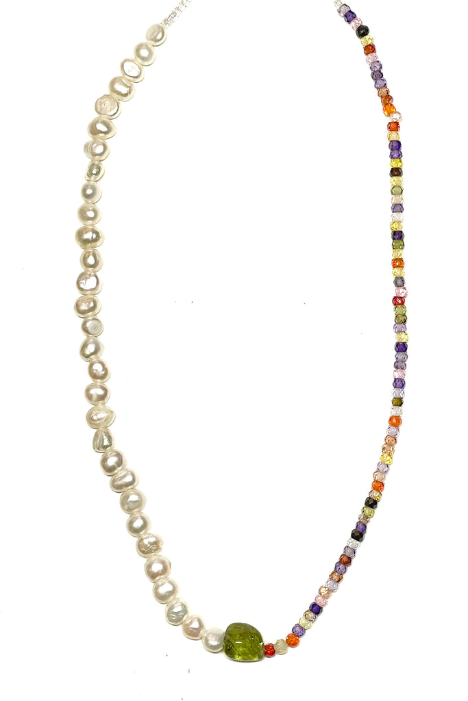 A chic and cool summer necklace made with creamy white pearls on one side and tiny faceted stones on the other, with a Peridot centre piece.