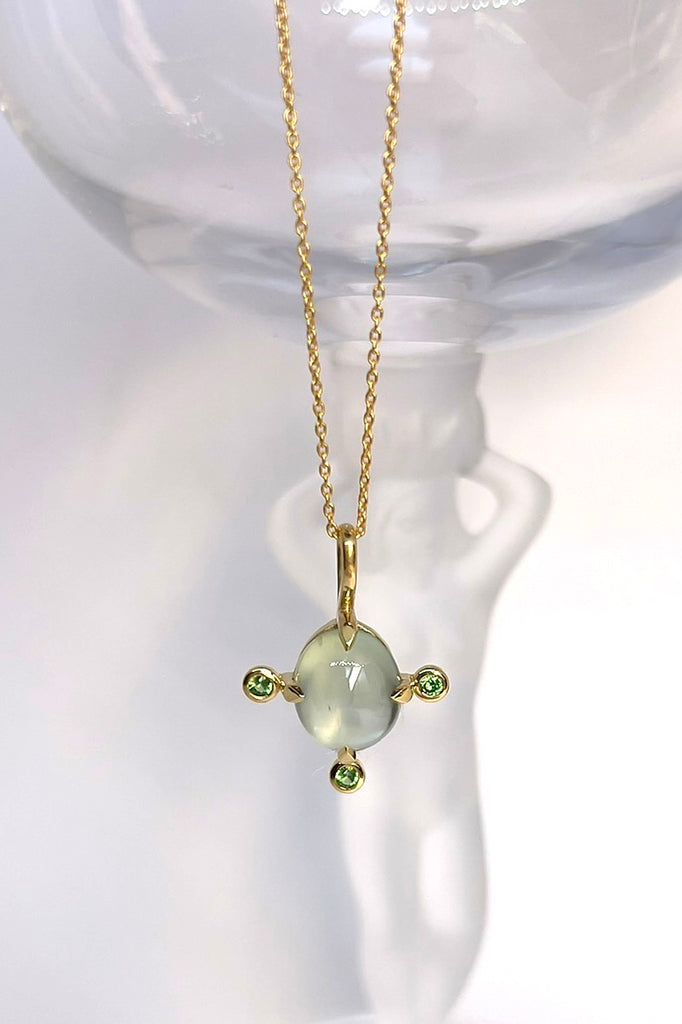 The pendant and chain are 9ct gold vermeil on a base of 925 silver, the gold is 2.5microns thick so will never rub or discolor An oval cabochon cut top quality Prehnite gemstone set in 9ct gold vermeil. Side stones are Sapphires.