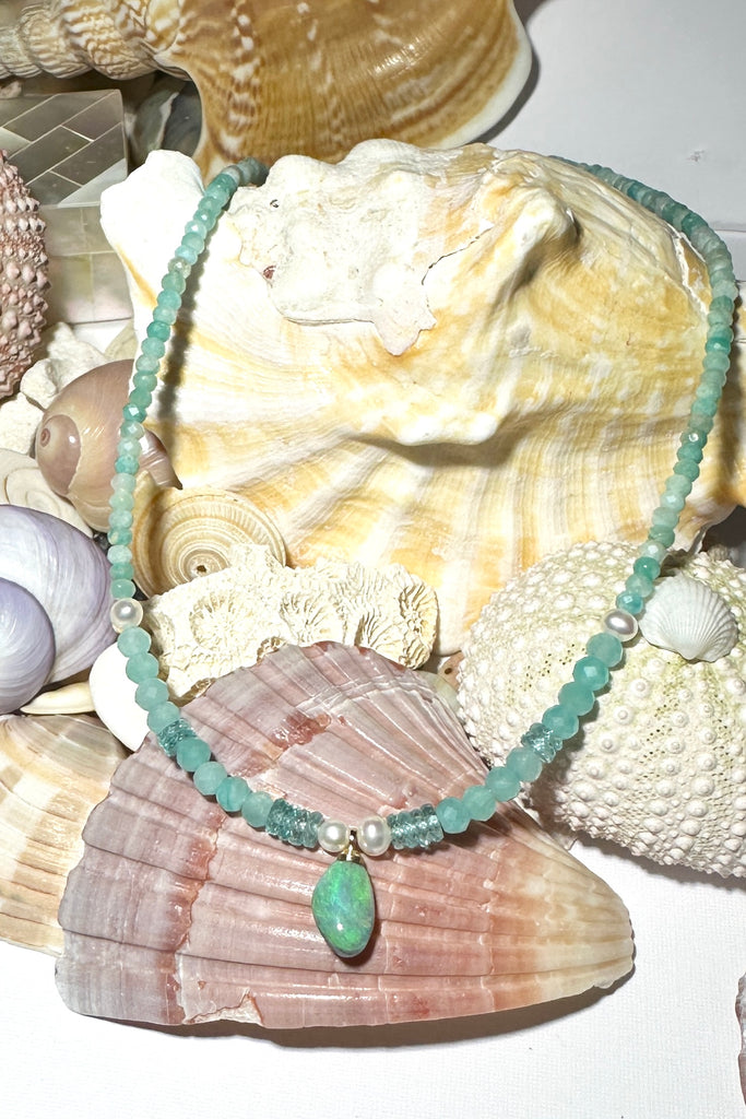 The prettiest splash of perfect wave blue, a splash of perfection, a swirl of green and teal on this tiny black opal pendant. Strung on little faceted Amazonite beads and a pretty pearls as a highlight.