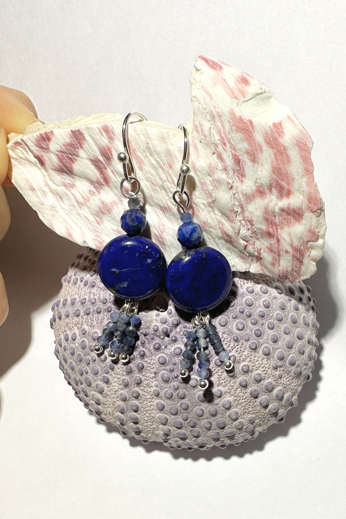 these earrings with dark blue Lapis Lazuli beads have three little tassels of paler blue Sodalite beads dancing below.&nbsp;