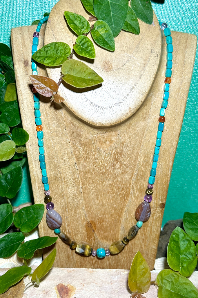 There is a magic feel in this piece, all the natural stones in perfect harmony. Made in Noosa Australia from old and new stock beads.  Beads include natural Turquoise, Carnelian, Tigers Eye, hand carved Agate leaves and Amethyst.&nbsp;