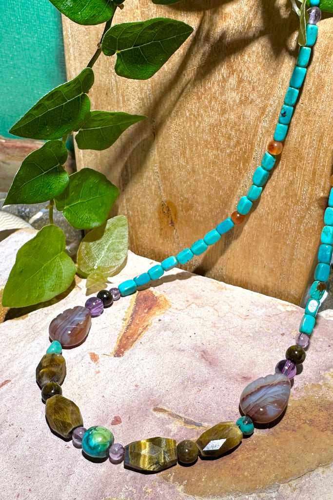 There is a magic feel in this piece, all the natural stones in perfect harmony. Made in Noosa Australia from old and new stock beads.  Beads include natural Turquoise, Carnelian, Tigers Eye, hand carved Agate leaves and Amethyst.&nbsp;